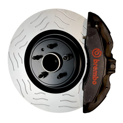 High-performance disc brake kit featuring S-slotted rotors and black Brembo calipers with red logo for performance vehicle upgrades.